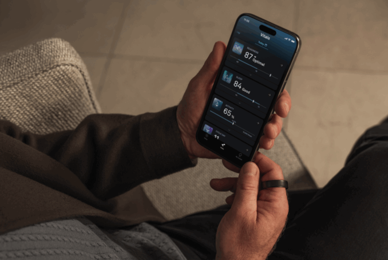Oura member holding phone