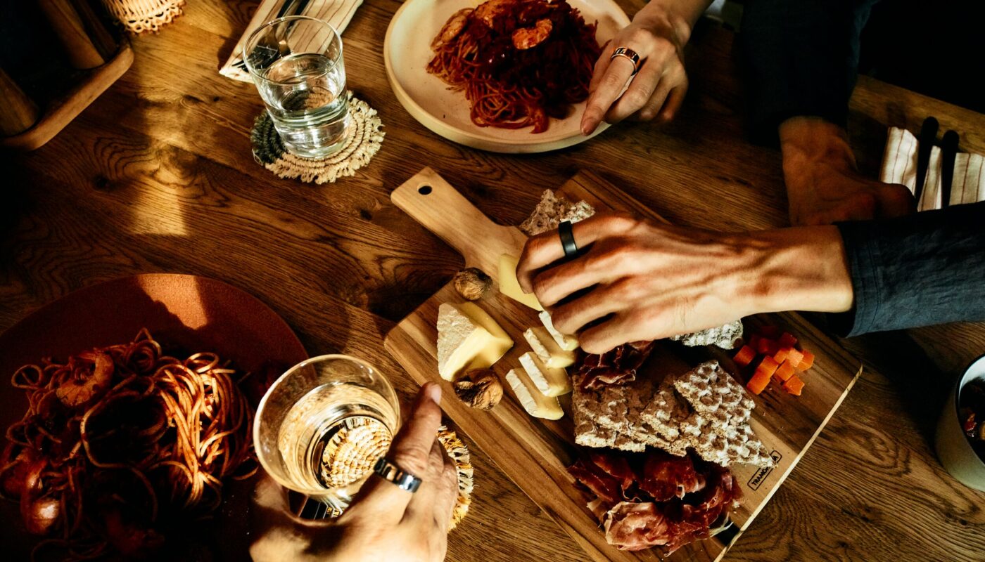 People sharing a meal wearing Oura Ring