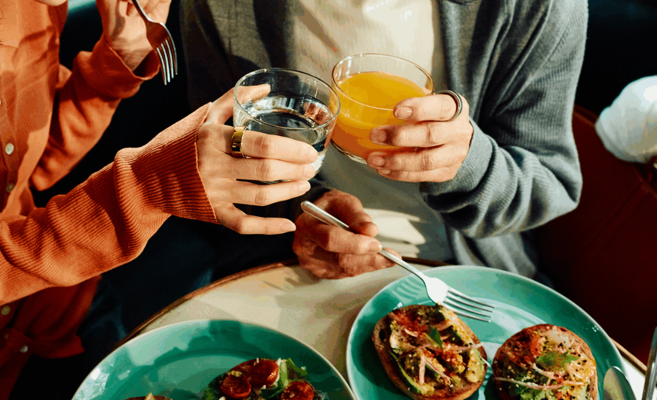 Women sharing a meal together wearing Oura Ring
