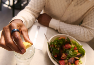 Person eating at restaurant wearing Oura Ring