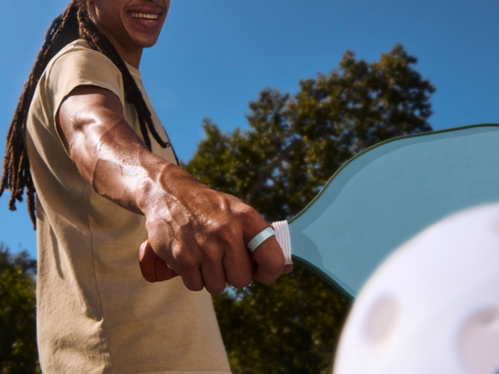 Person playing pickleball wearing Oura Ring 4 Ceramic