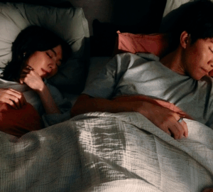 Couple sleeping wearing Oura Ring