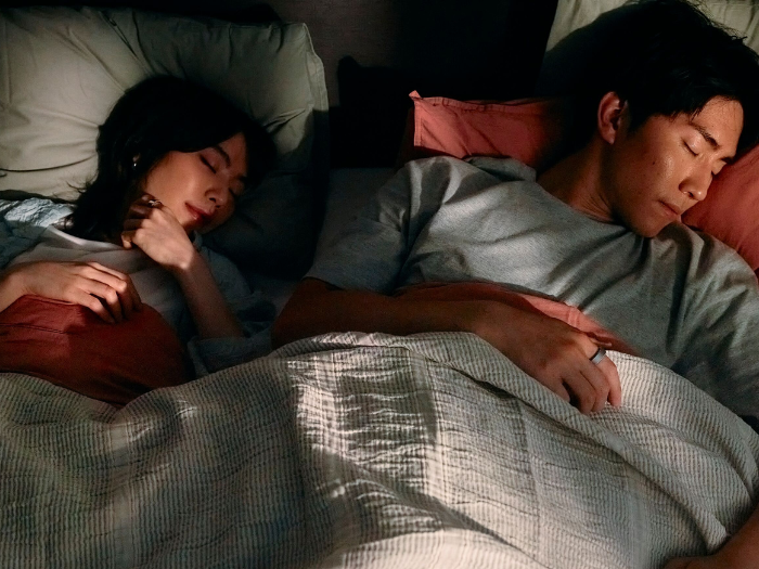 Couple sleeping wearing Oura Ring