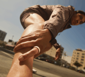 Man stretching wearing Oura Ring 4 Ceramic in Cloud