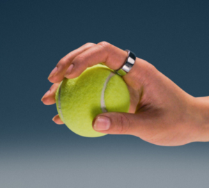 Hand wearing Oura Ring 4 holding a tennis ball