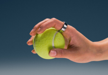 Hand wearing Oura Ring 4 holding a tennis ball