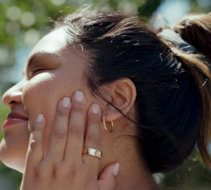 Woman wearing Oura Ring touching her face