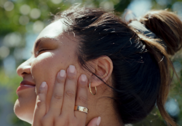 Woman wearing Oura Ring touching her face