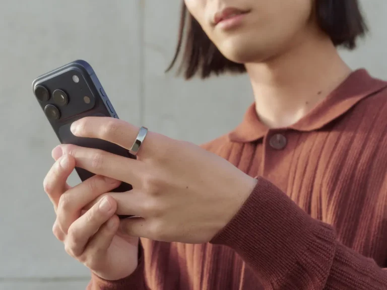 Woman wearing Oura Ring and looking at phone screen