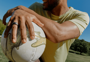Man wearing Oura Ring 4 holding soccer ball
