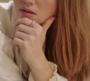 Woman with red hair wearing Oura Ring 5