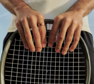 Man wearing Oura Ring 5 holding a tennis racket