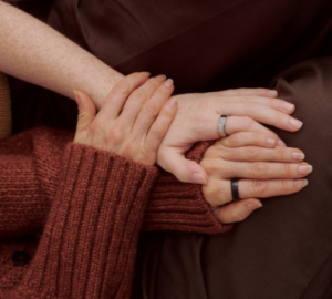 People holding hands wearing Oura Ring 5