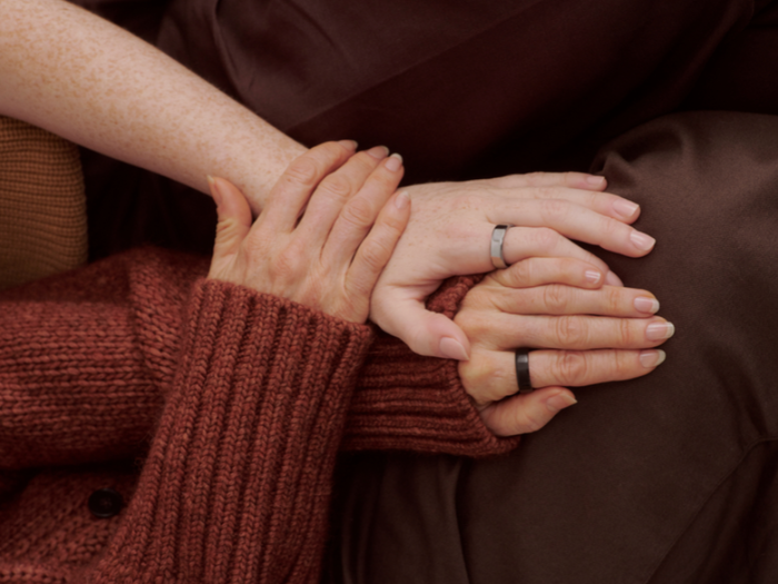 People holding hands wearing Oura Ring 5