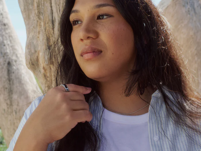 A woman wearing her Oura Ring to track her stress