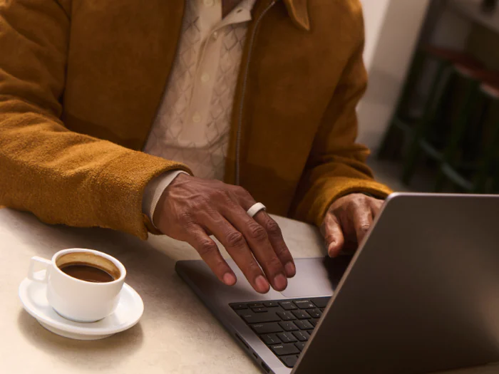 Man working on laptop wearing Oura Ring