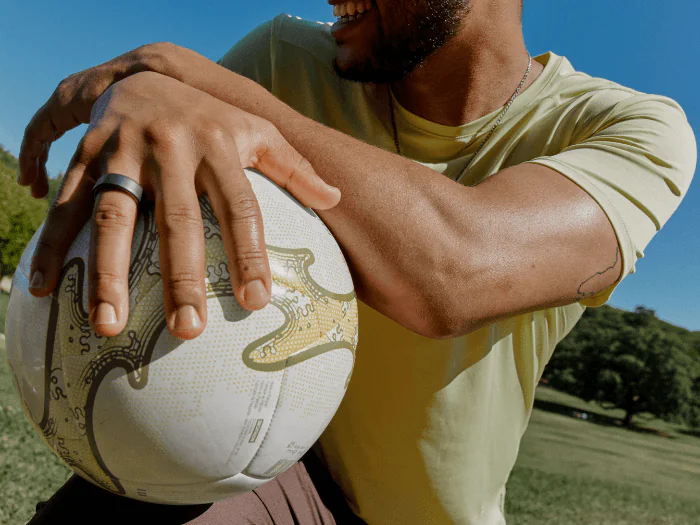 Man wearing Oura Ring 4 holding soccer ball