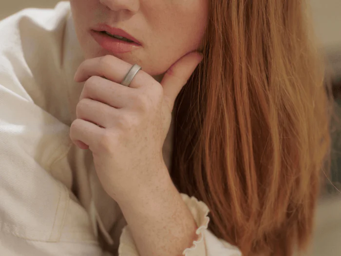 Woman with red hair wearing Oura Ring 5